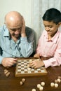 Grandson and Grandfather Playing Chess