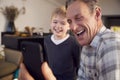 Grandson With Grandfather Smiling And Taking Selfie On Mobile Phone At Home Royalty Free Stock Photo