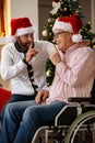 Grandson and grandfather talking secrets on Christmas