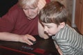 Grandson and grandmother using a computer at home