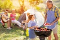 Grandson grilling barbecue with grandfather Royalty Free Stock Photo