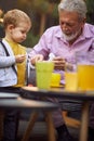 Grandson have fun with their grandfather outdoor at home Royalty Free Stock Photo