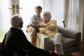 Grandson is in a living room with grandparents