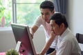 Grandson teaching grandfather how to Using computer and technology in home . young Teacher help senior Man learning to connect