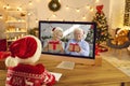 Grandson video calling his grandma and grandpa who have prepared him Christmas presents Royalty Free Stock Photo