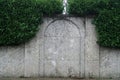 Granit wall with green grass fence in form of door that were in the past