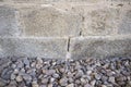 Granite ashlars wall with river pebble stones as ground