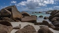 Granite boulders piled up on a sandy beach. Royalty Free Stock Photo