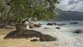 Granite boulders are scattered in the surf. Royalty Free Stock Photo