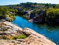 Granite Cliffs Reflecting on Inks Lake at Devils Waterhole Royalty Free Stock Photo