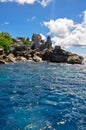 Granite coastline view of the tropical island of Marianne in Seychelles with blue sky