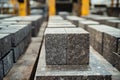 Granite cobblestone blocks neatly stacked, forming a perfect cube, ready for transport and use in construction or paving Royalty Free Stock Photo