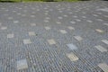 granite cobblestone tiles in a large area and inside cut irregularly Royalty Free Stock Photo