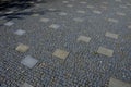 granite cobblestone tiles in a large area and inside cut irregularly Royalty Free Stock Photo