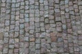 Granite cobblestoned pavement background. Stone pavement texture. Abstract background of old cobblestone pavement close-up in Prag Royalty Free Stock Photo