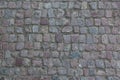 Granite cobblestoned pavement background. Stone pavement texture. Abstract background of old cobblestone pavement close-up in Prag Royalty Free Stock Photo