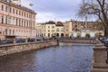 The granite embankment of the Griboyedov Canal in St. Petersburg on a wet cloudy autumn day