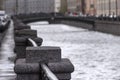 The granite embankment of the Griboyedov Canal in St. Petersburg on a wet cloudy autumn day