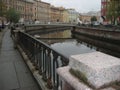 The granite embankment of Griboyedov canal with views of the lion bridge.