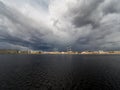 Granite embankment of the river with storm clouds over the water Royalty Free Stock Photo