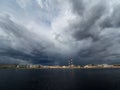 Granite embankment of the river with storm clouds over the water Royalty Free Stock Photo