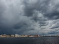 Granite embankment of the river with storm clouds over the water Royalty Free Stock Photo