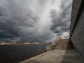 Granite embankment of the river with storm clouds over the water Royalty Free Stock Photo