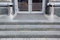 Granite gray threshold steps with a foot mat at the entrance.