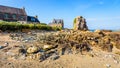 Granite houses and boulder in the harbor of Pors Hir in Brittany, France