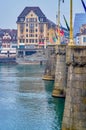 The granite Mittlere Brucke bridge and historical building on the bank of Rhine river, on April 1 in Basel, Switzerland