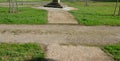 Granite natural paving of irregular shape, brown gray paving in the pedestrian zone in park near the bridge with stairs. garden pa