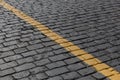 Granite pavement with a yellow stripe on the diagonal Royalty Free Stock Photo