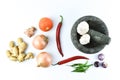 Granite pestle and mortar with cooking ingredients over white background Royalty Free Stock Photo