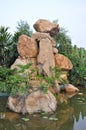 Granite rockery in pond water Royalty Free Stock Photo