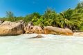 Granite rocks and palm trees by the sea in Anse Lazio Royalty Free Stock Photo