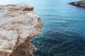 Granite sand colored cliff in sea