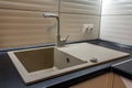 Granite sink and water faucet in new modern kitchen interior Royalty Free Stock Photo