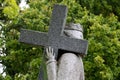 Granite statue of woman bearing the cross