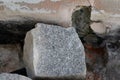 Granite stone block resting on old wall construction Royalty Free Stock Photo