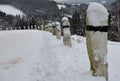 Granite stone bollards handmade stone. Along the road with a black stripe. snowy mountain pass in a natural mountain landscape. wo