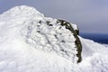 Granite stone, covered with bizarre ice outgrowths, on top of the mountain