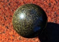 Granite stone polished ball on a granite slab Royalty Free Stock Photo
