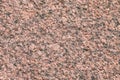 Granite stone surface. Red and black texture of a natural crystalline rock as a background