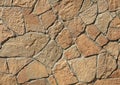 Granite stone wall, background. Mosaic structure of surface, made of granite rocks (bricks) Royalty Free Stock Photo