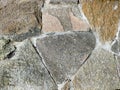 Granite stone wall surface. These stones have been joined together using mortar.