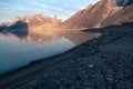 Granite tower of Mt.Asgard and surrounding peaks reflect in waters of Glacier Lake in remote arctic valley of Akshayuk