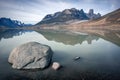 Granite tower of Mt.Asgard and surrounding peaks reflect in waters of Glacier Lake in remote arctic valley of Akshayuk