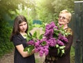 Grannie and grand daughter with lilac violet flowers