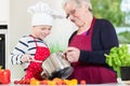 Granny cooking together with her grandson Royalty Free Stock Photo