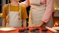 Granny and girl baking Christmas muffins for family celebration, holidays